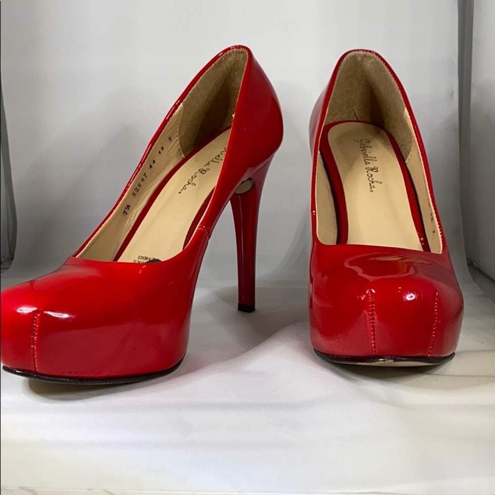 Red Patent leather platform pumps.